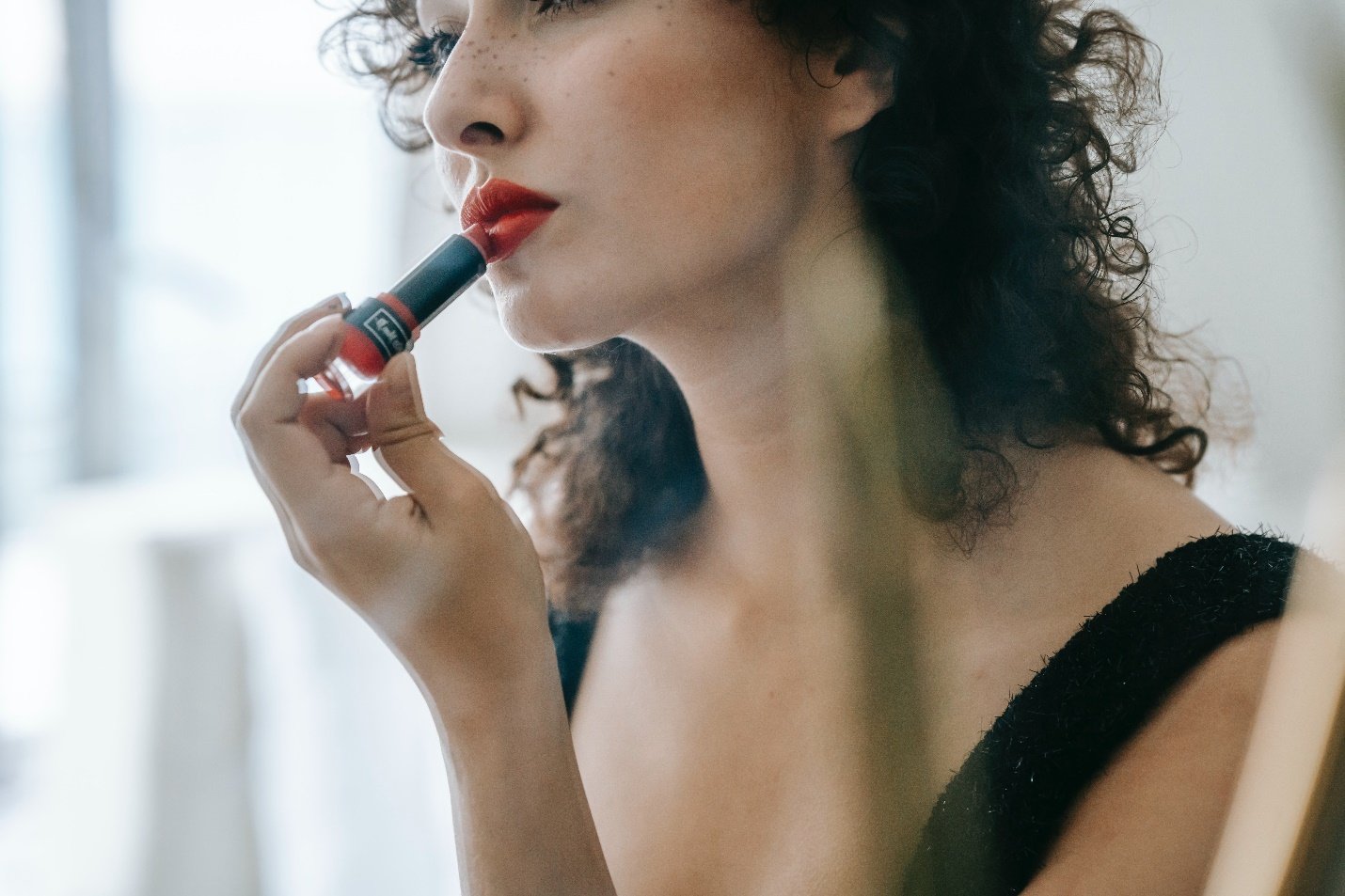 Woman applying lipstick