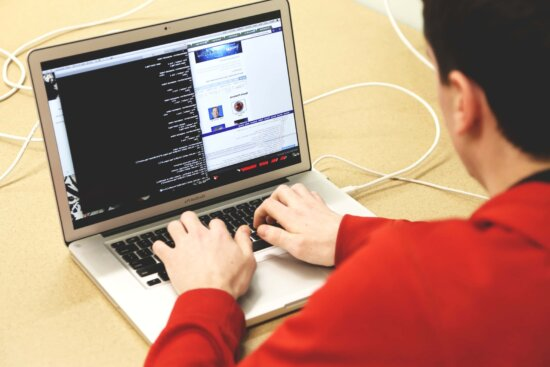 Person using a coding interface on a laptop