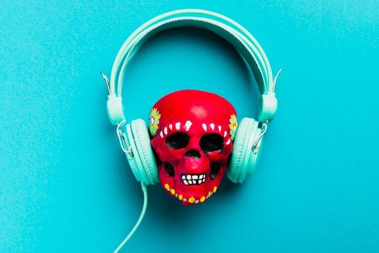 Red skull wearing turquoise headphones