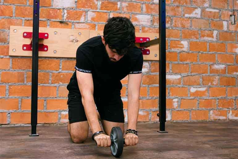 Person exercising with a roller on the gym floor