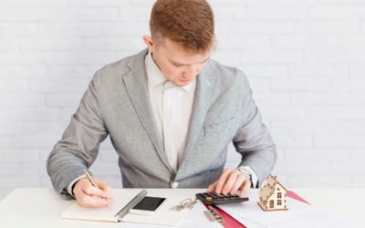 A real estate agent using a calculator