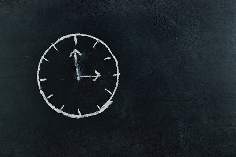 A chalk clock on a blackboard