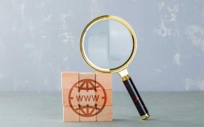 Wooden blocks showing an icon of a globe with the letters WWW in the centre of it next to a magnifying glass