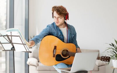 A person playing guitar and reading music